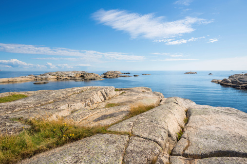 waves on mediterranean sea with pebble beach and green water