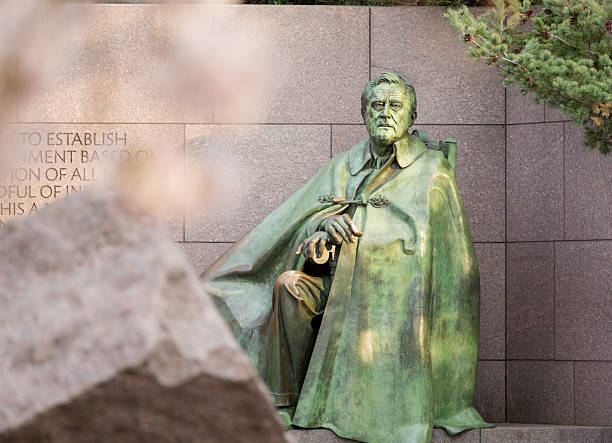 Early blurred Japanese cherry blossoms surround the monument to President Franklin Delano Roosevelt in Washington DC