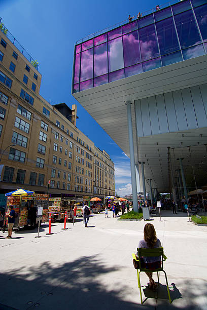 Whitney museum, High Line Manhattan on a sunny day New York, USA - June 17, 2015: Lady sitting in front of Whitney museum, High Line Manhattan on a sunny day 21st century style stock pictures, royalty-free photos & images