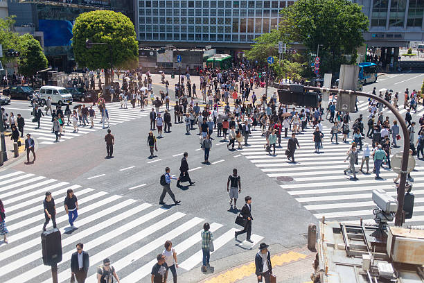 Shibuya Crossing Aerial Aerial photograph of people walking across the Shibuya crossing in Tokyo, Japan middle of the road stock pictures, royalty-free photos & images