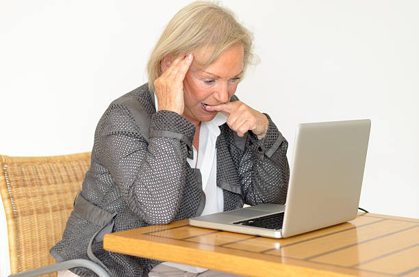 istock Active blond senior woman with formal clothes sitting thoughtful 477835466