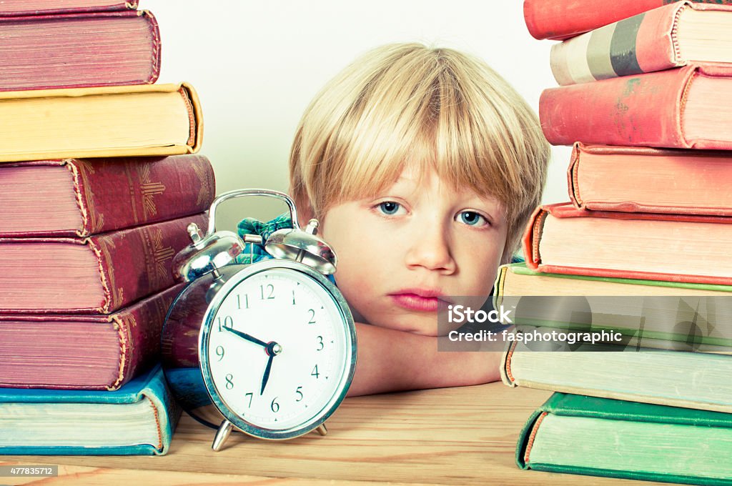 Homework Child with a bored expression doing his homework 2015 Stock Photo