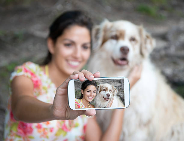 istock Woman taking a Selfportrait with her Australian Shepherd Dog 477835719