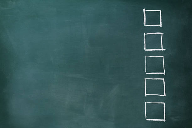 istock Row of blank check boxes on blackboard with copy space 477836513