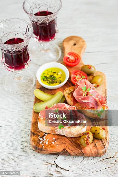 Toast With Ham Olives And Cherry Tomatoes In Olive Board Stock Photo - Download Image Now