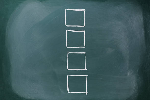 istock Row of blank check boxes on blackboard with copy space 477837091