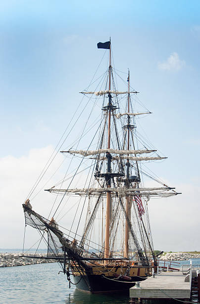 istock Tall Sailing Ship Harbored at Dock Pier Under Blue Sky 477838805