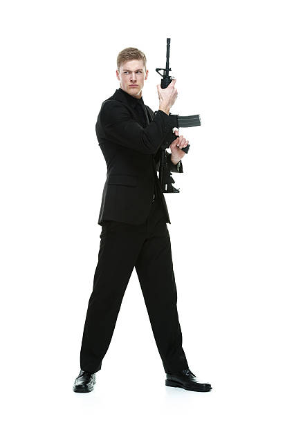 istock Businessman standing with machine gun 477838971