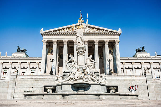 Austrian parliament with Pallas Athena statue, Vienna, Austria Beautiful view of Austrian parliament building with famous Pallas Athena fountain in Vienna, Austria. revival stock pictures, royalty-free photos & images