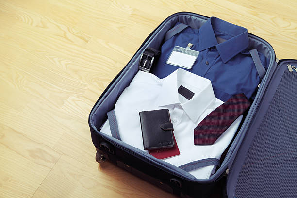 Image of businessman's clothes in travel bag stock photo