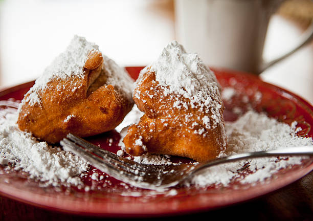 fritters Beignets covered in powdered sugar beignet stock pictures, royalty-free photos & images