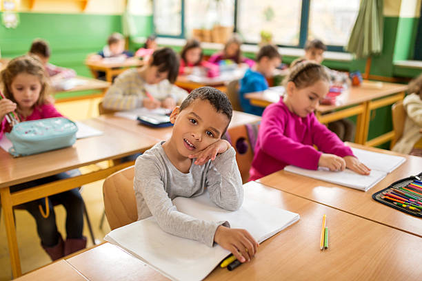 istock Bored African American schoolboy in the classroom. 477841444