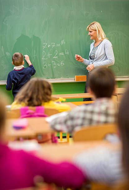 istock Elementary school children having mathematics lesson in the classroom. 477841556