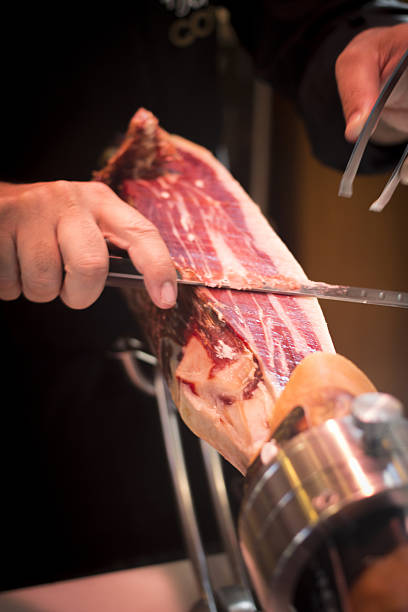 istock Cutting leg of Iberian cured ham in Spanish wedding 477842004