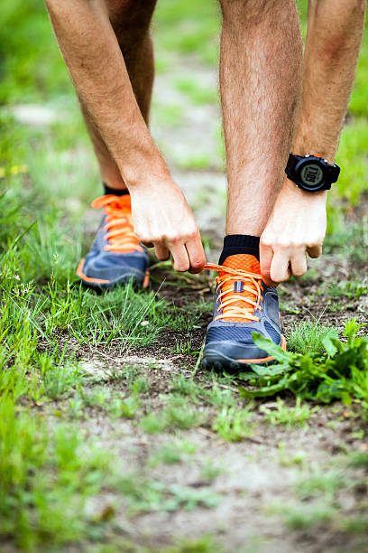 istock Runner tying sports shoe 477842283