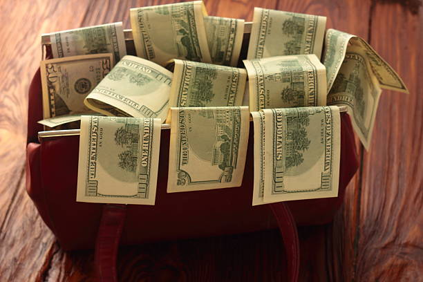 istock bag full of dollar bills 477843350