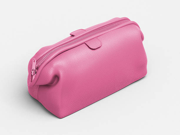 Pink leather clutch Pink leather clutch closeup on a light background make up bag stock pictures, royalty-free photos & images