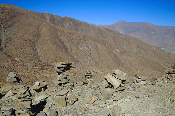 Some cairns-stacked stones seemingly of slate half way up to the 4793 ms.high Kamba La-pass on the Southern Friendship Highway. Lhoka or Shannan pref.-Tibet.