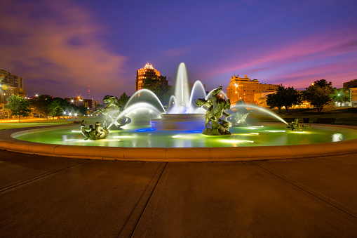 The J.C Nichols Memorial Fountain over looking the skyline of Kansas City early in the morning.