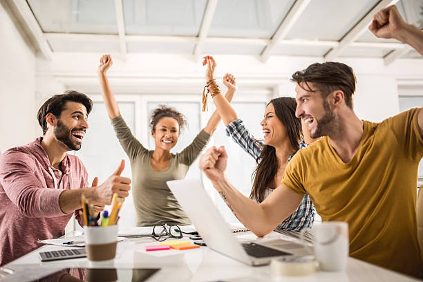 istock Cheerful creative people celebrating their business achievement. 477844026