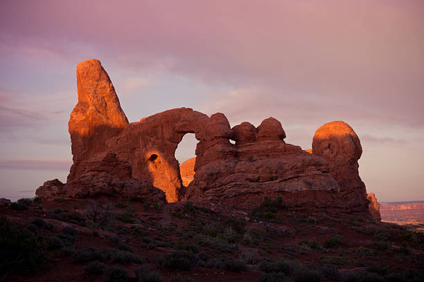istock Shadows at Rock Formation Arch under Pink Sky at Sunrise 477844970