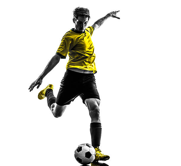 brazilian soccer football player young man kicking silhouette one Brazilian soccer football player young man kicking in silhouette studio on white background kicking photos stock pictures, royalty-free photos & images