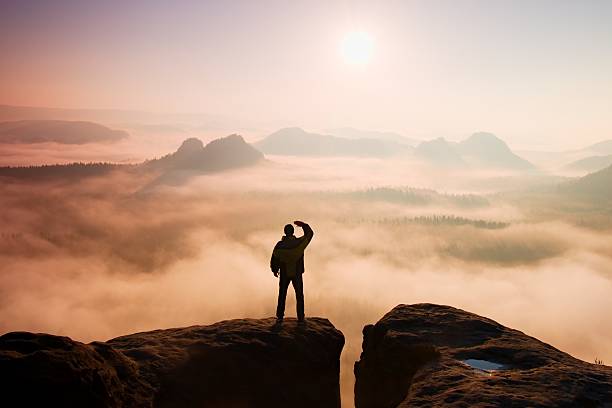 istock Man stands on peak of sandstone rocky park 477847708