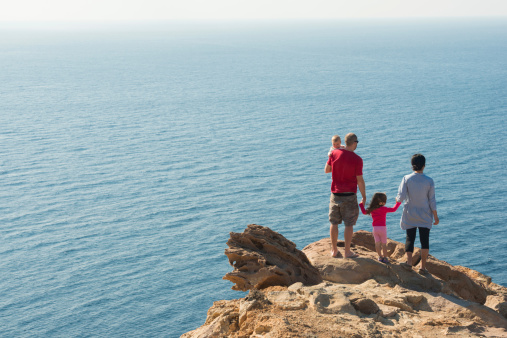 Family taking in ocean views from a seaside cliff