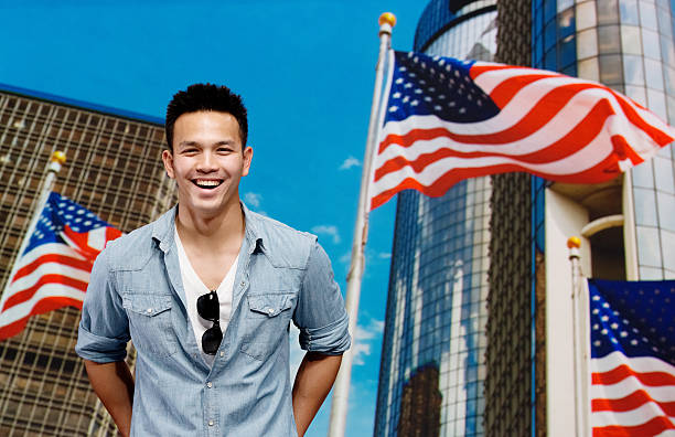 istock Man on street with american flags behind him 477848865