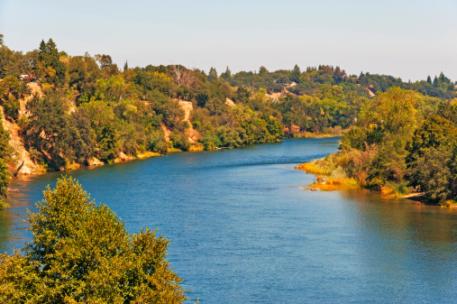 This wonderful view of the American River is from an older walking bridge in historic Fair Oaks, California a Sacramento Metro City.