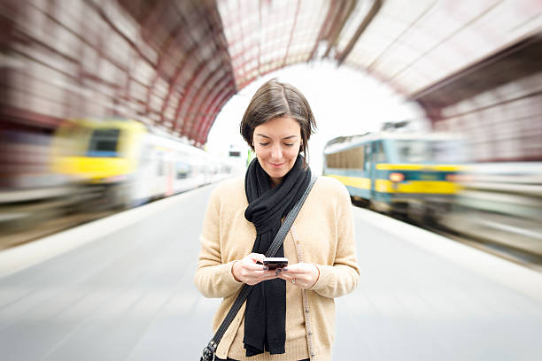 istock Travel - Using Smartphone at Railway Station 477850010