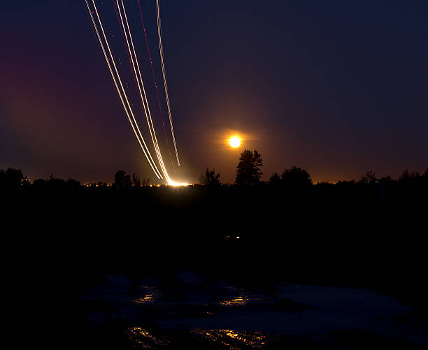 istock Passenger planes take off from runways against beautiful night sky 477851674