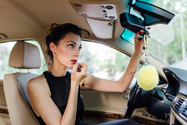 istock Beautiful woman paints her lips 477852088