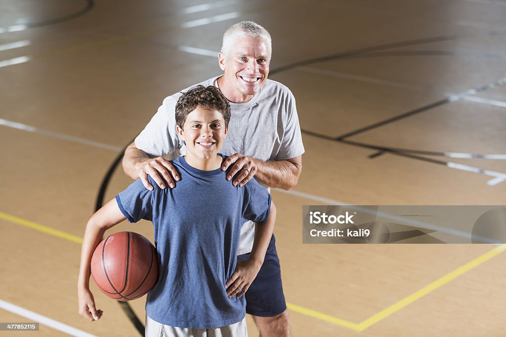 Niño con entrenador de baloncesto - Foto de stock de Gimnasio escolar libre de derechos