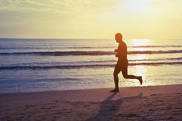 istock silhouette of runner on the beach 477853306