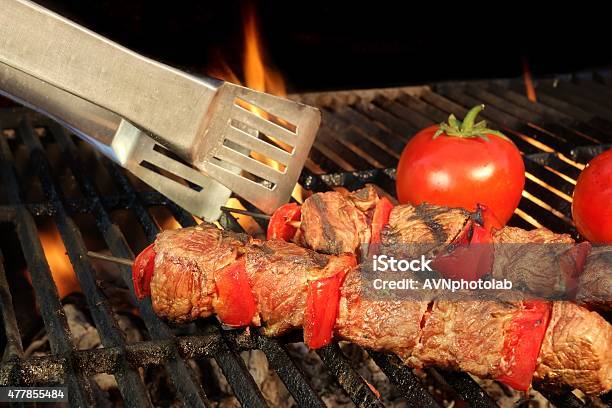 Tongue Hold Bbq Beef Shish Kebab On The Hot Grill Stock Photo - Download Image Now - 2015, Barbecue - Meal, Barbecue Grill