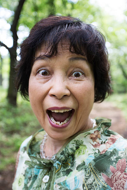 senior donna sorpresa giapponese - laughing women shirt vertical foto e immagini stock
