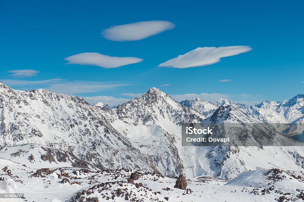 Snowy blue mountains in clouds Snowy blue mountains in clouds. Winter ski resort 2015 Stock Photo