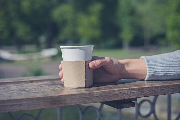 istock Female hand holding paper cup 477856254