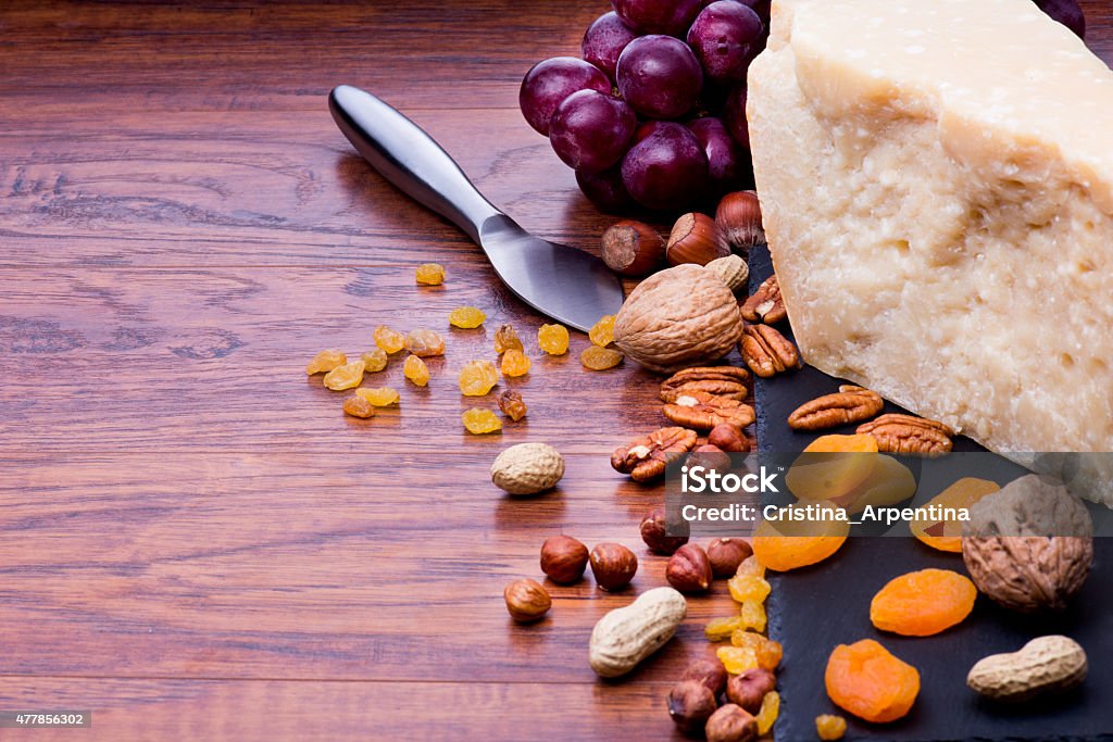 Parmesan Parmesan on wooden table with nuts 2015 Stock Photo