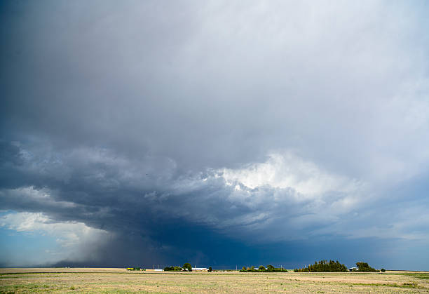 istock Large storm clouds build over dwarfed farms (XXXL) 477859673