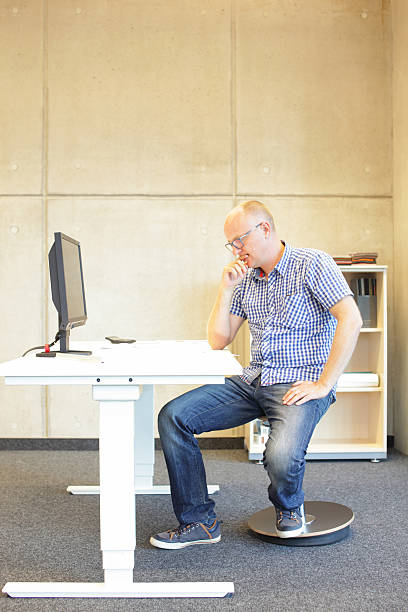 istock middle age man in bad sitting position on seat 477859736