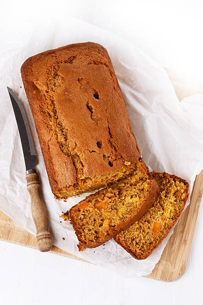 Pumpkin bread loaf over white wooden background stock photo