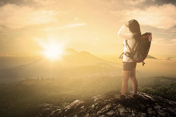 istock Hiker enjoying sunrise view on mountain 477863212