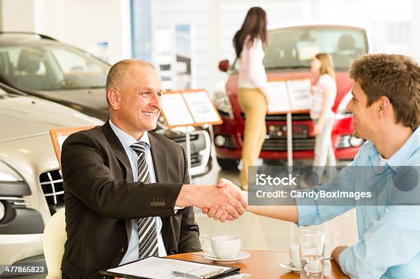 Customer And Car Salesman Shaking Hands Stock Photo - Download Image Now - Buying, Car, Car Dealership