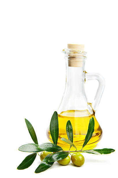istock Olive oil and branch with olives on white 477865931