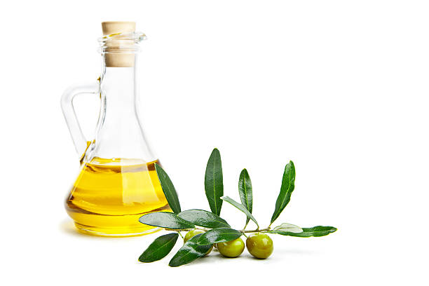 istock Olive oil and branch with olives on white 477865937