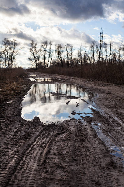 istock Mud and puddles on the dirt road 477867358