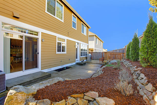 istock Yellow house with back yard and blue sky. 477870741
