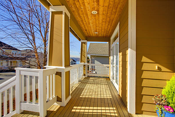 istock Front sunny happy yellow porch with white trim. 477871859